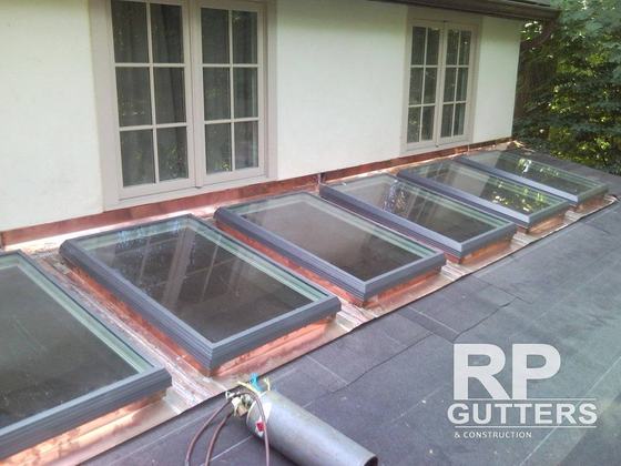 Copper-trimmed skylights on a flat roof