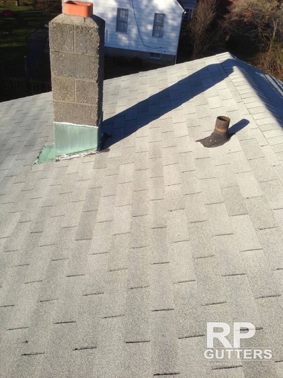Asphalt shingle roof with a flashed vent pipe