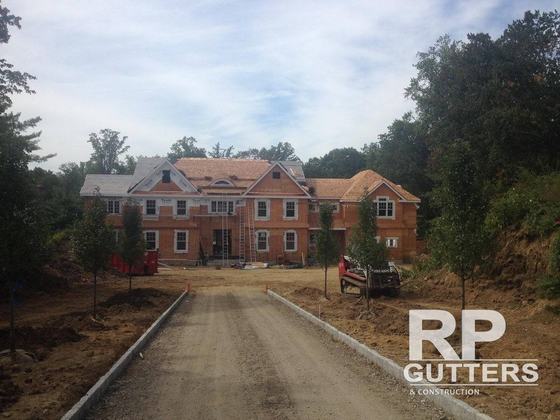 Large new brick home at the end of a new driveway