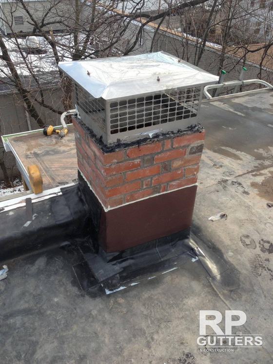 New brick chimney with a mesh cap and flashing