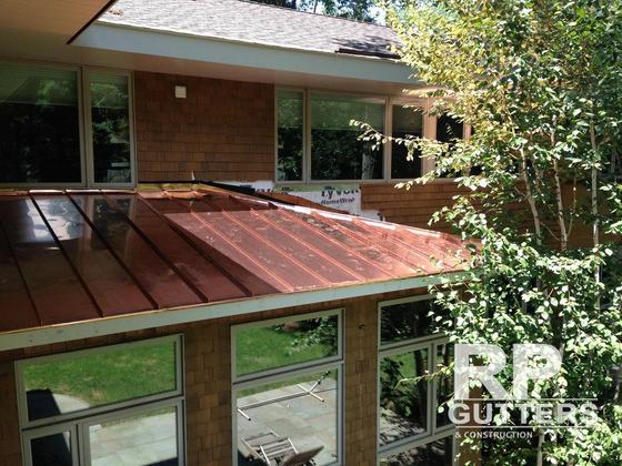 Copper roofing over a glass sunroom
