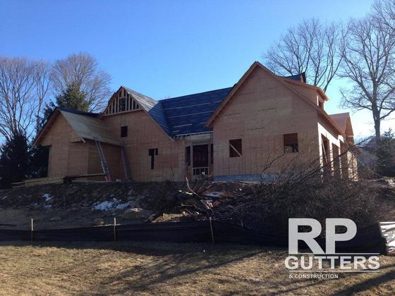 New brick and shingle home with roof underlayment