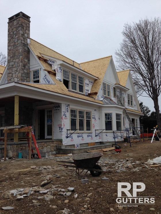 New stone and shingle home under construction