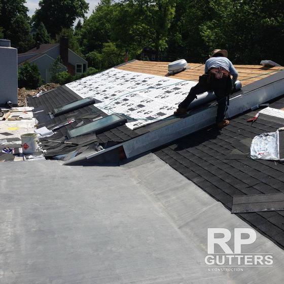 Roofer installing flashing on a new roof