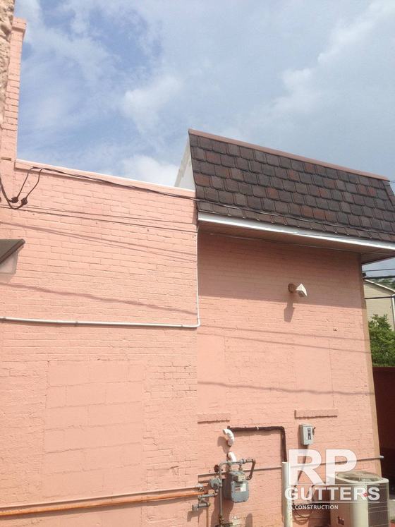 Roof edge detail on a painted masonry building