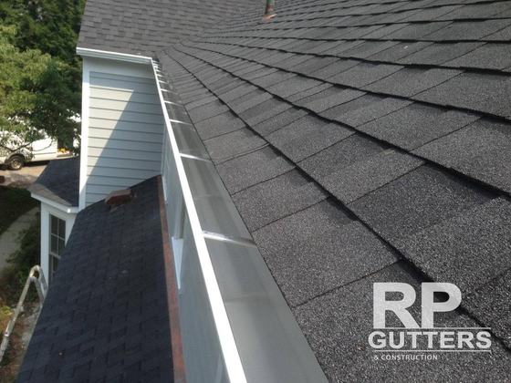 Gutter along a shingle roof edge