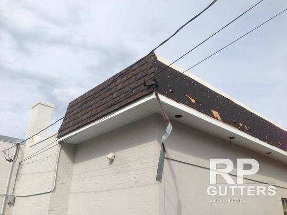 Gutter and drip edge on a wood-shingle roof