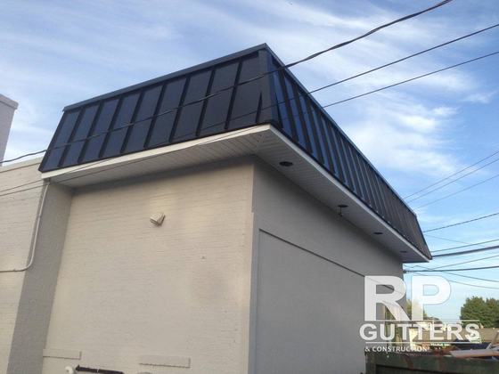 Black standing-seam metal roof on a bump-out