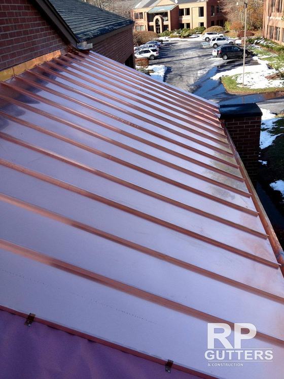 Copper standing-seam roof beside a chimney